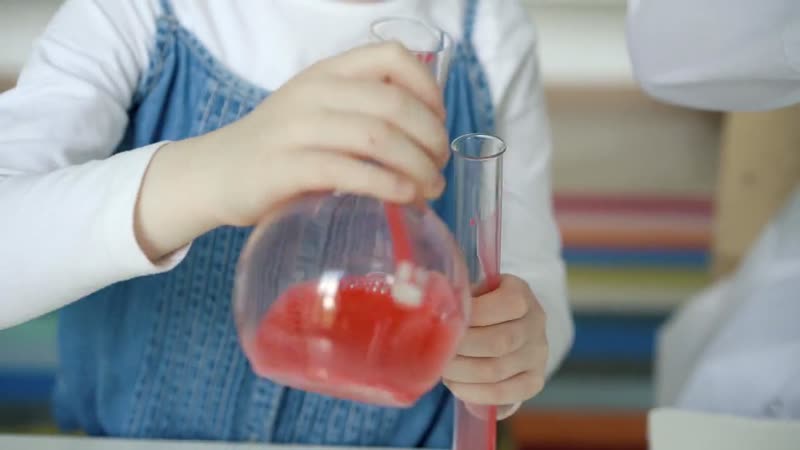 Child and teacher doing a science experiment